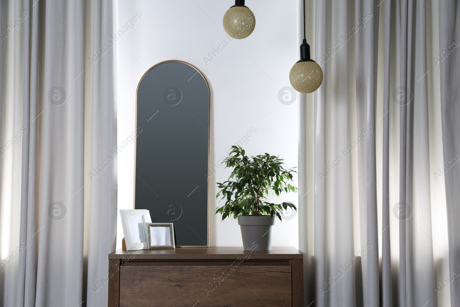 Photo of Stylish room interior with wooden console table and beautiful decor elements