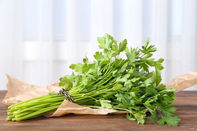 Bunch of fresh green parsley on wooden table