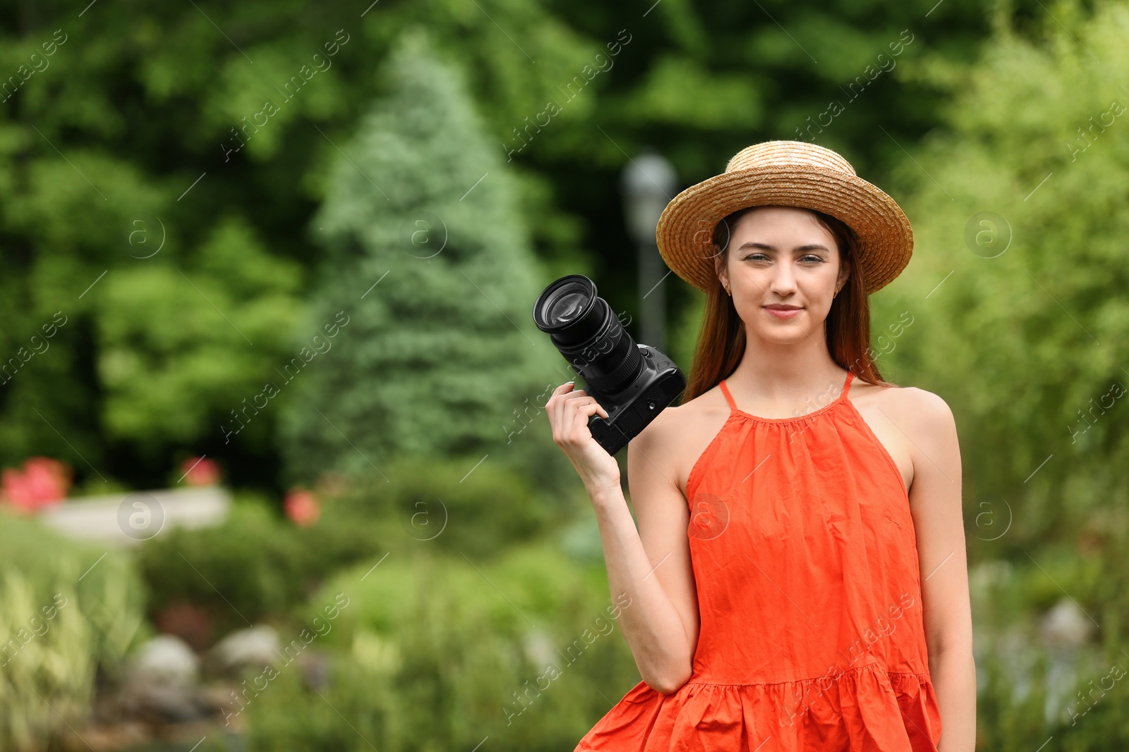 Photo of Photographer with professional camera in park. Space for text