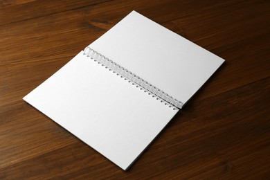 Blank paper brochure on wooden table. Mockup for design