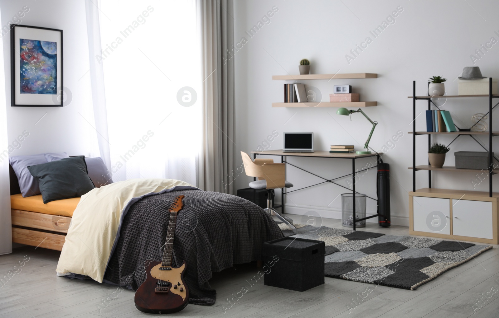 Photo of Modern teenager's room interior with workplace and bed