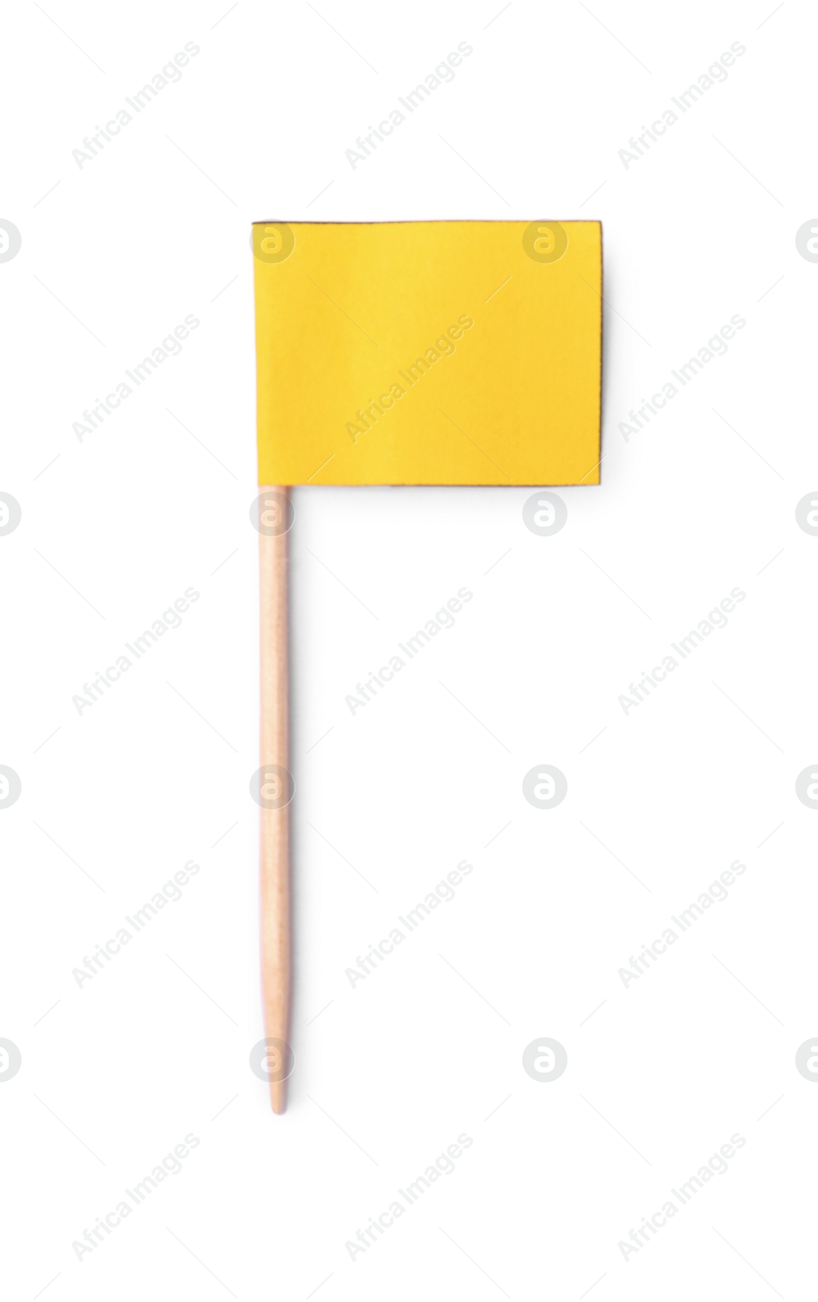 Photo of Small yellow paper flag isolated on white, top view