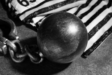 Photo of Prisoner ball with chain on grey table, closeup