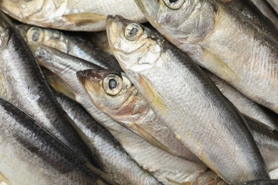 Photo of Fresh raw sprats as background, top view