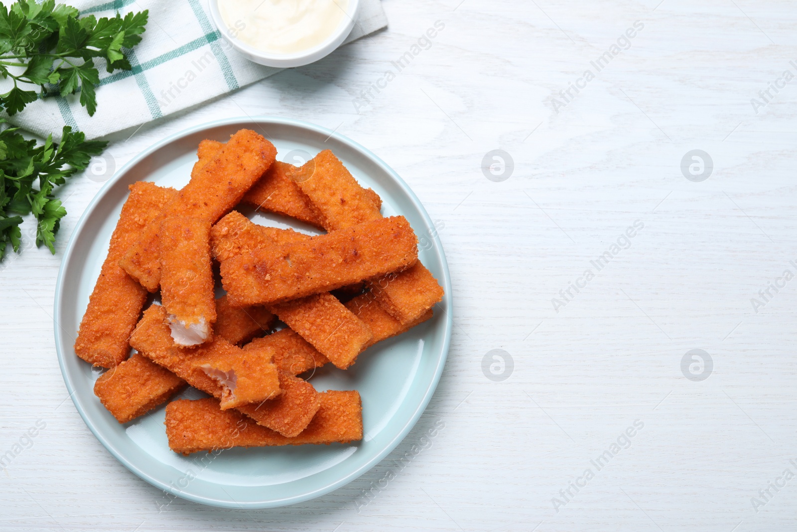 Photo of Fresh breaded fish fingers served on white wooden table, flat lay. Space for text