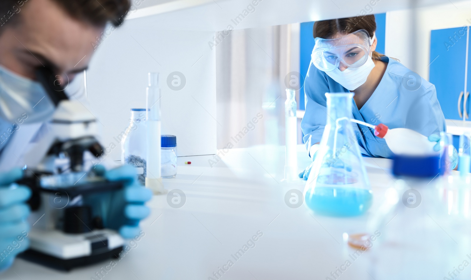 Photo of Young scientists doing research and analysis in chemical laboratory