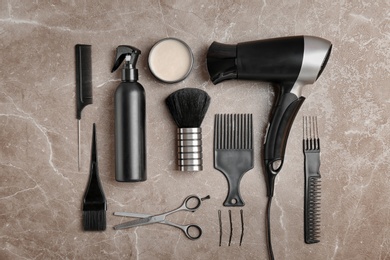 Photo of Flat lay composition with professional hairdresser tools on color background