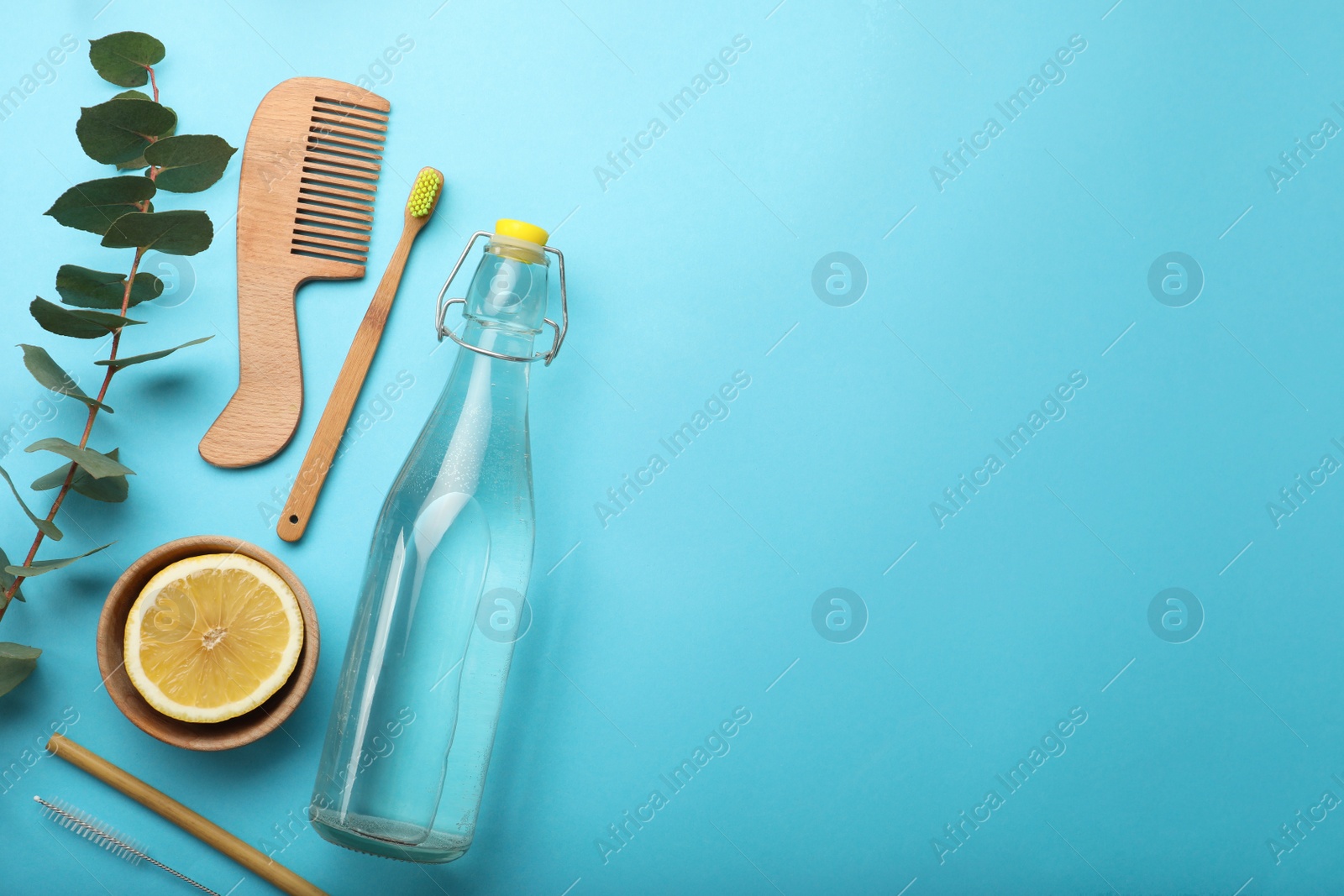 Photo of Flat lay composition with eco friendly products on turquoise background, space for text