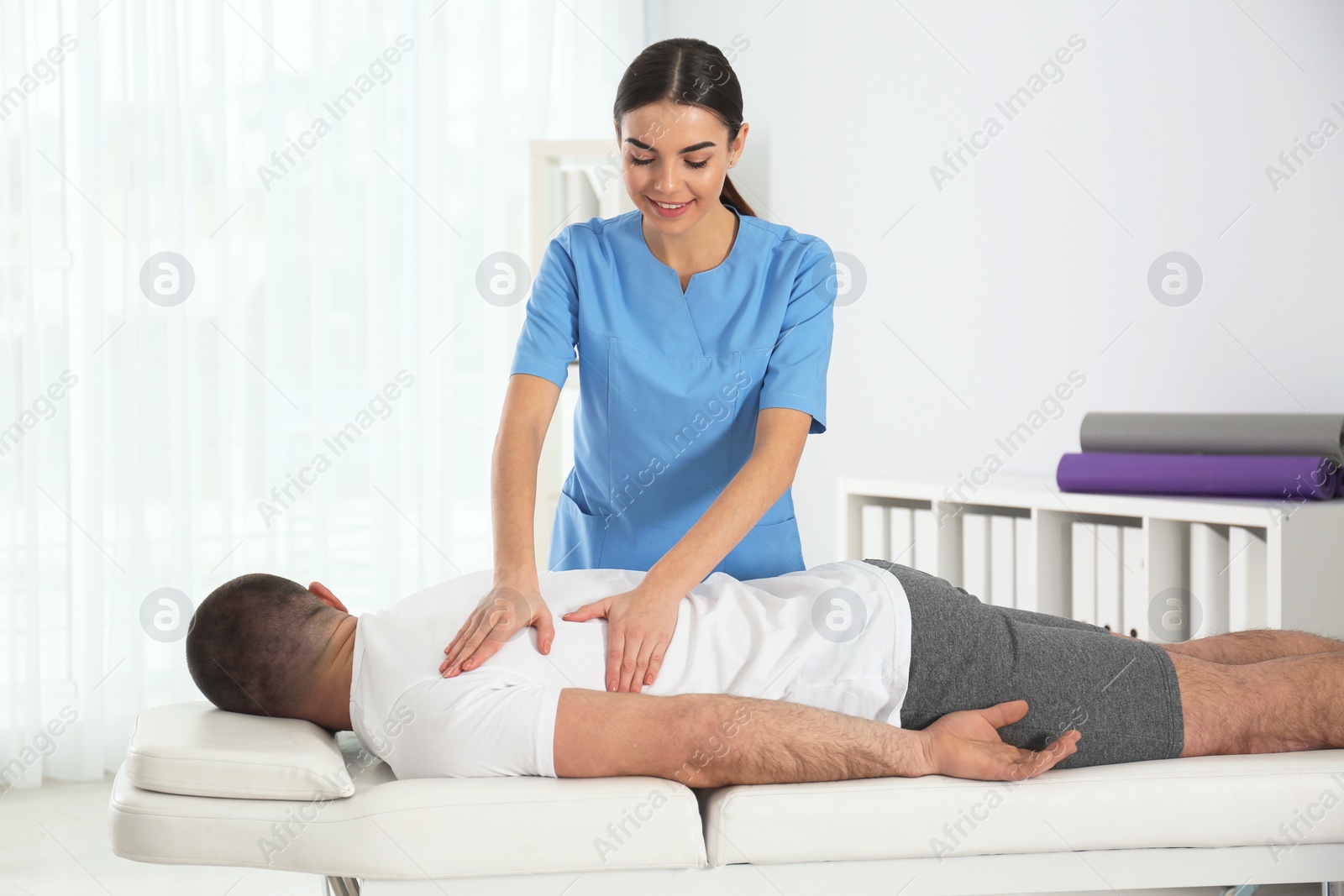 Photo of Doctor working with patient in hospital. Rehabilitation massage