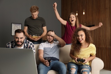 Emotional friends playing video games at home