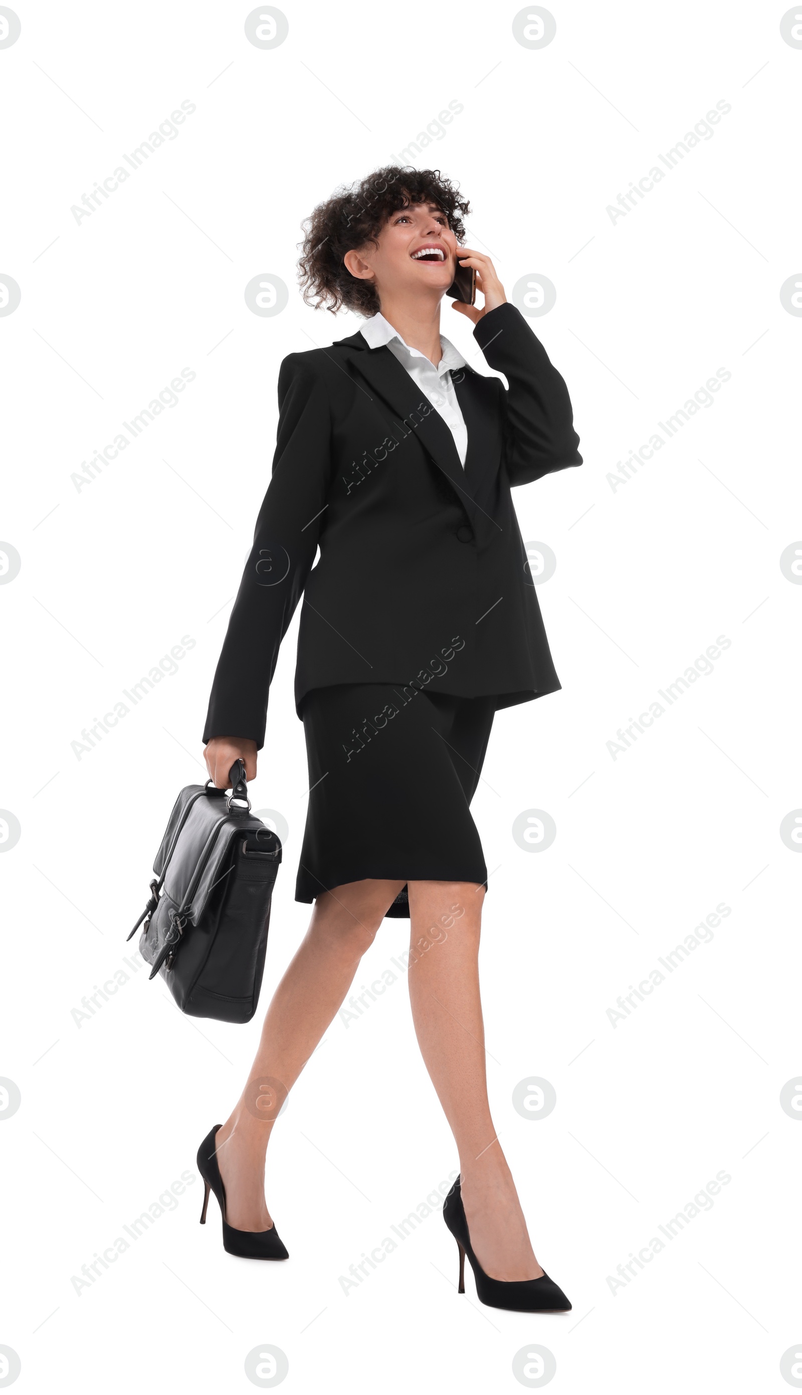 Photo of Beautiful businesswoman with briefcase talking on smartphone against white background