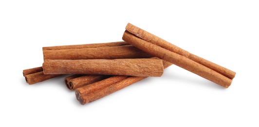 Photo of Pile of aromatic cinnamon sticks isolated on white