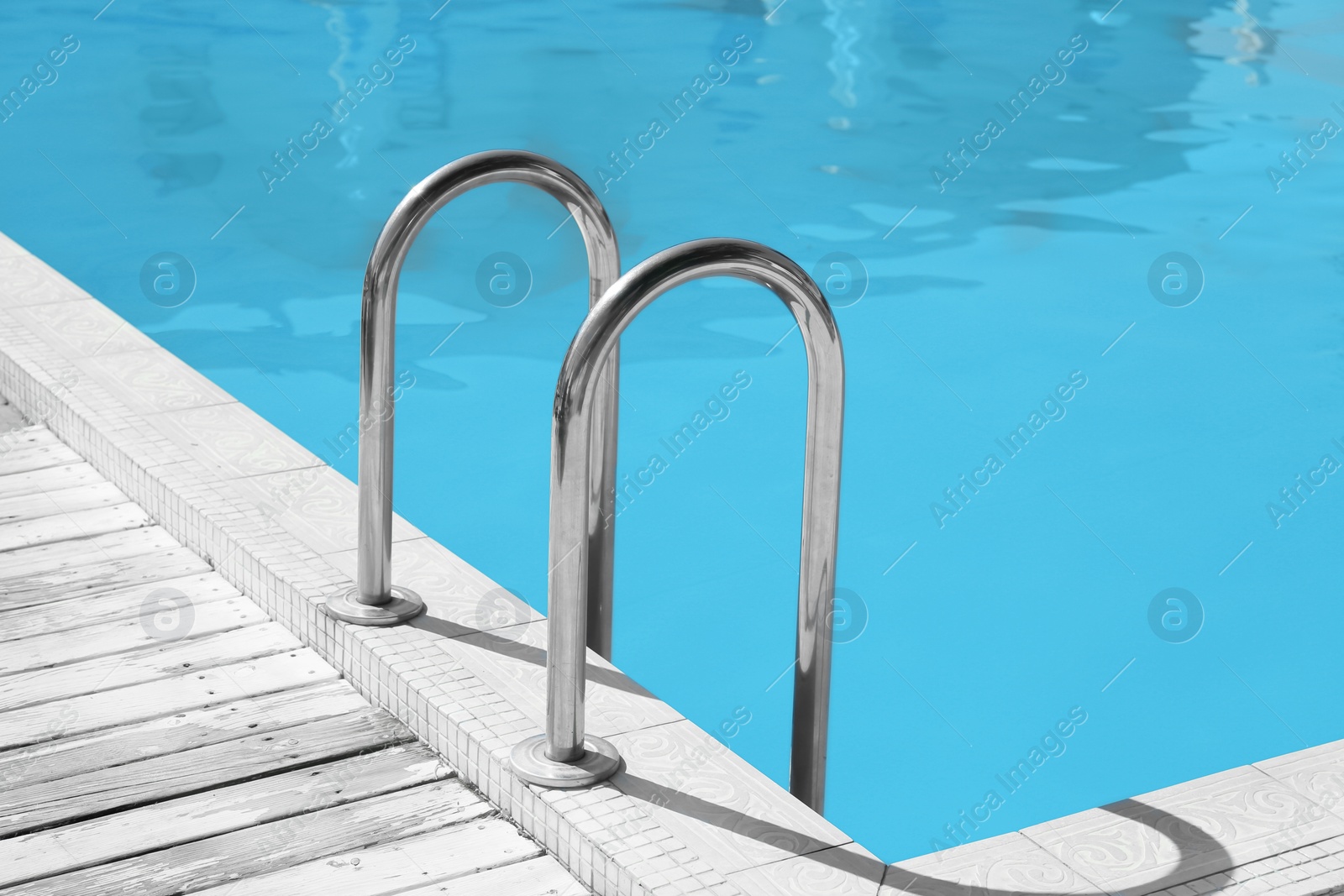 Photo of Modern swimming pool with step ladder outdoors