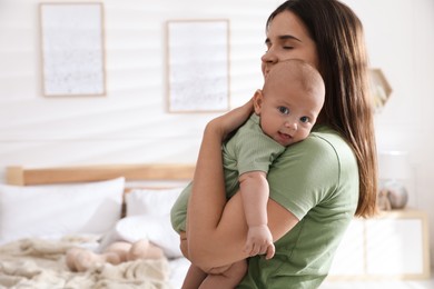 Mother with her cute baby at home