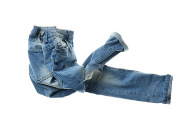 Photo of Rumpled jeans isolated on white. Messy clothes