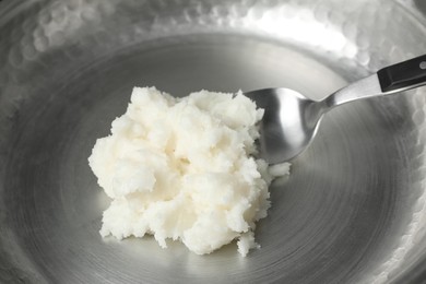 Photo of Frying pan with coconut oil and spoon, closeup. Healthy cooking