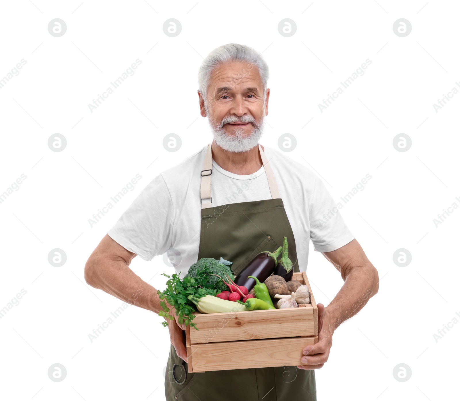 Photo of Harvesting season. Farmer holding wooden crate with vegetables on white background