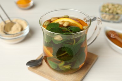 Immunity boosting drink on white wooden table, closeup