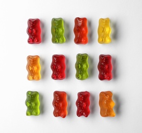 Delicious color jelly bears on white background, top view