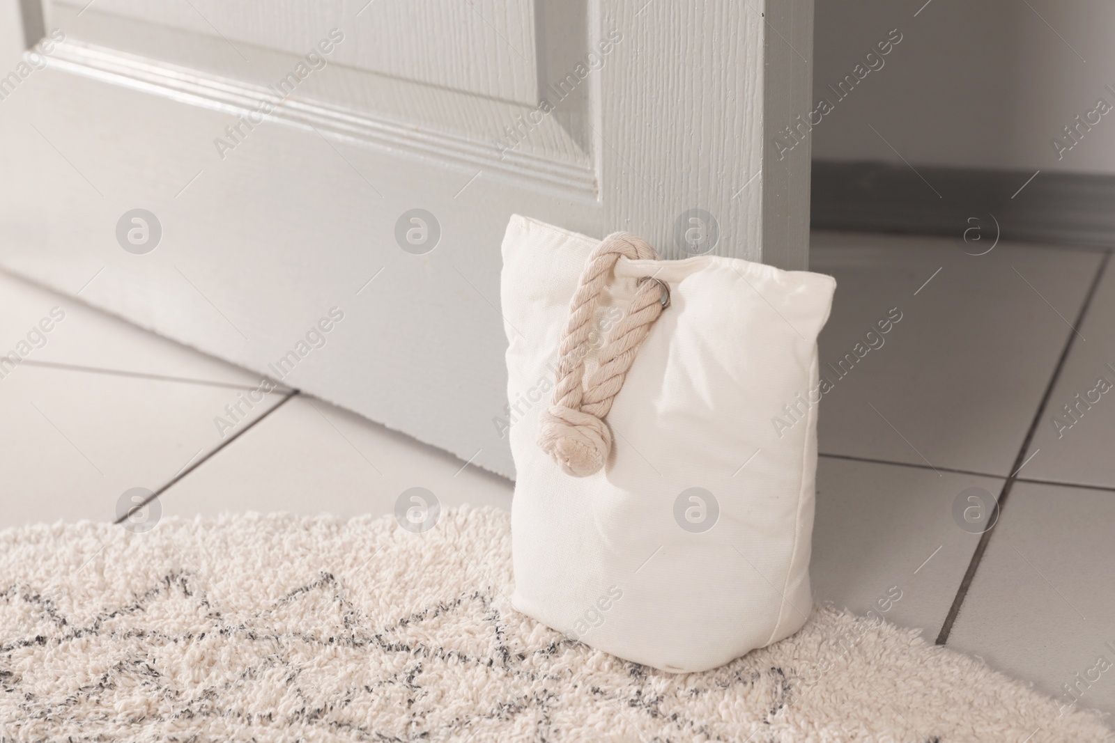 Stuffed bag holding wooden door at home Photo of Stuffed bag holding wooden door at home