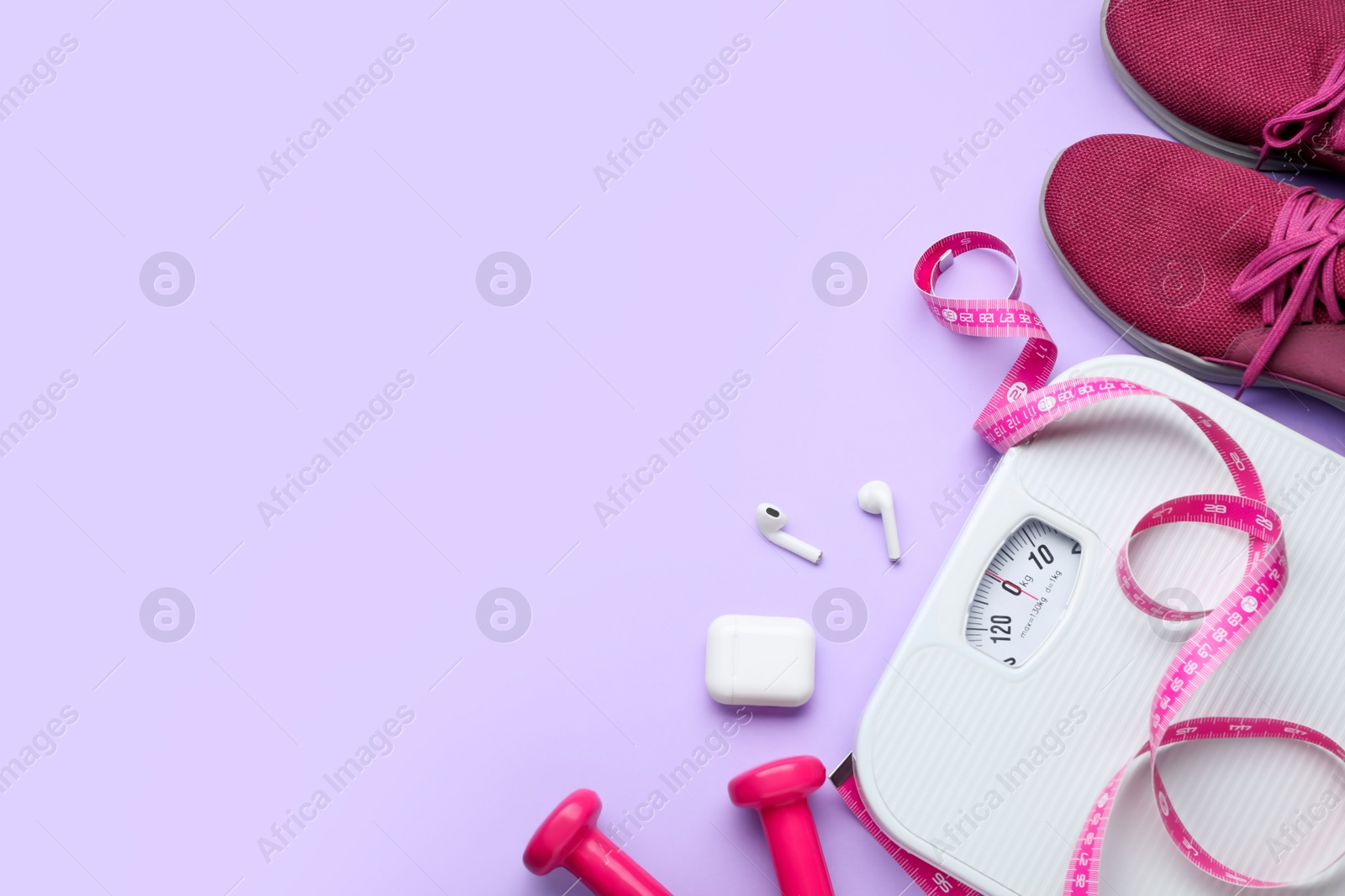 Photo of Flat lay composition with scales and measuring tape on violet background, space for text