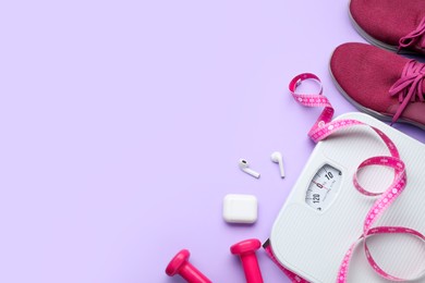 Photo of Flat lay composition with scales and measuring tape on violet background, space for text