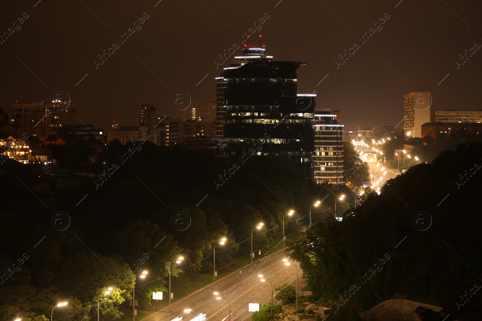 Photo of Night road with illumination in modern city