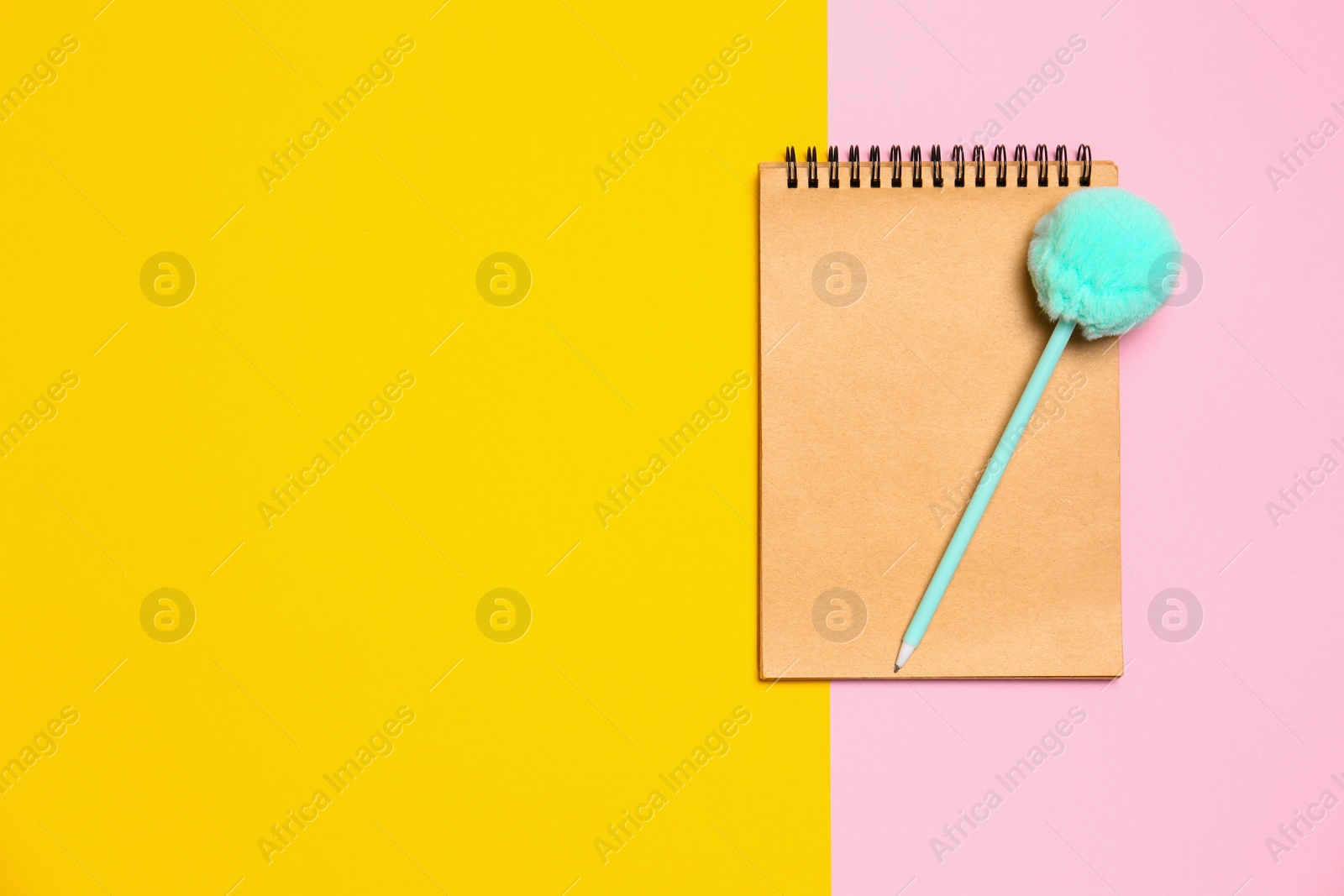 Photo of Notebook and pen on color background, top view. Space for text