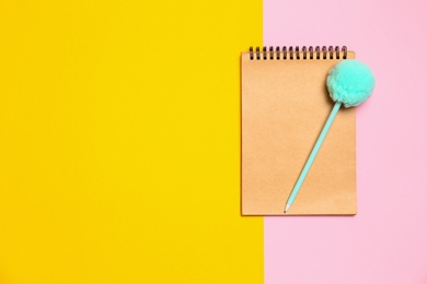 Photo of Notebook and pen on color background, top view. Space for text