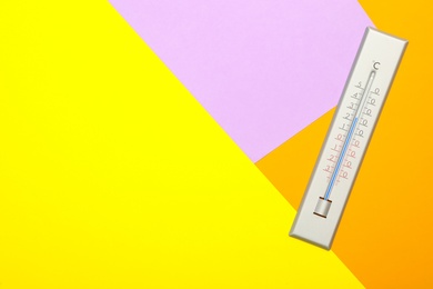 Photo of Weather thermometer on color background, top view. Space for text