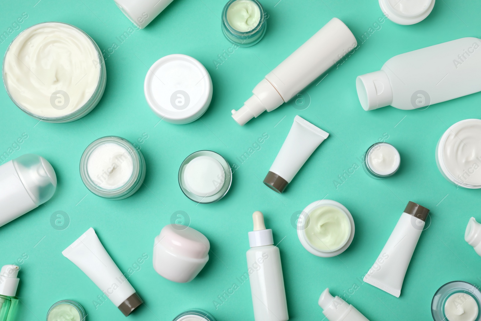 Photo of Flat lay composition with cosmetic products on color background