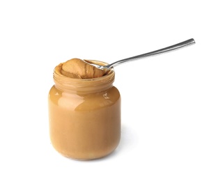 Photo of Jar and spoon with creamy peanut butter on white background