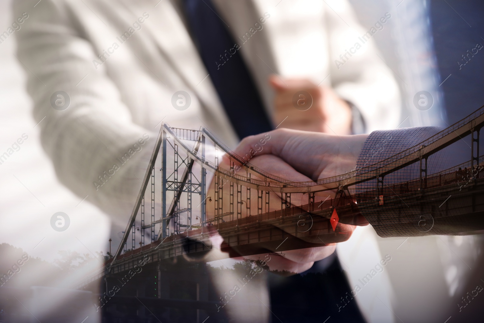 Image of Support or partnership concept. Double exposure with bridge and photo of businesspeople shaking hands