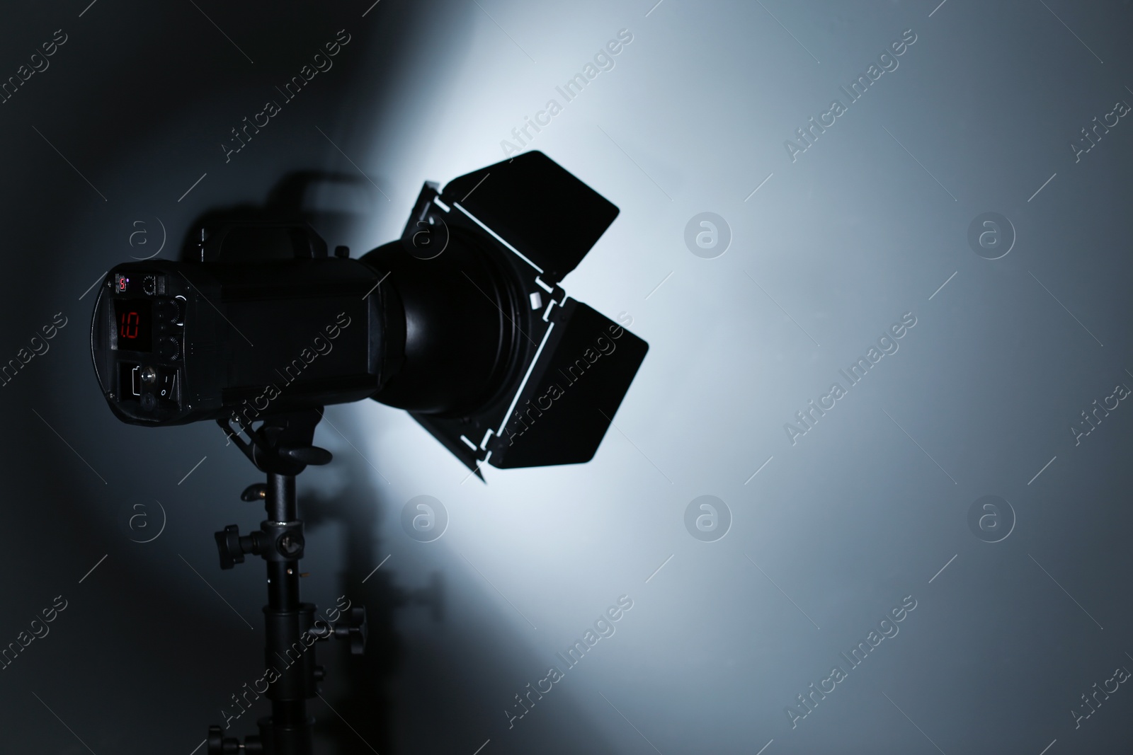 Photo of Professional photo studio lighting equipment on dark background. Space for text