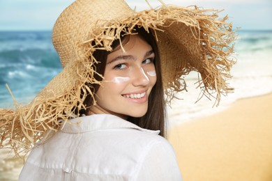 Image of Teenage girl with sun protection cream on her face near sea 
