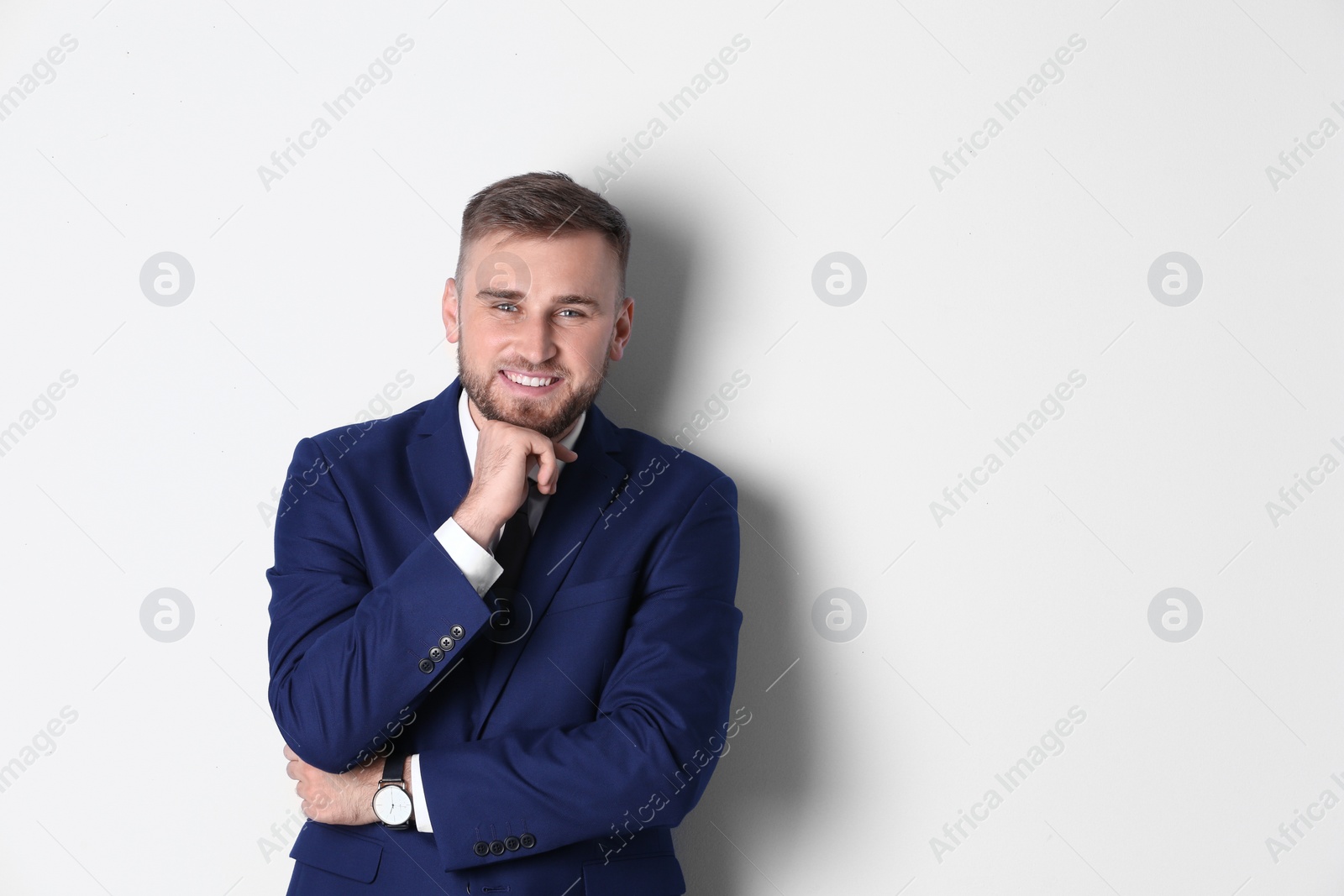 Photo of Portrait of happy man in office suit on white background