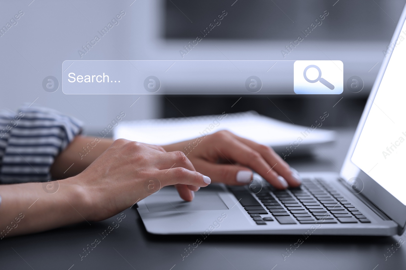 Image of Search bar of website over laptop. Woman using computer at black table, closeup