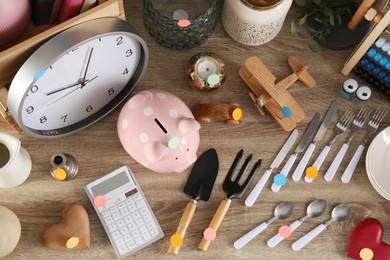 Photo of Many different items on wooden table, flat lay. Garage sale