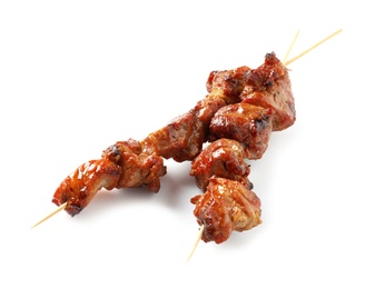 Photo of Skewers with delicious barbecued meat on white background