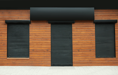 Stylish store facade with blank sign outdoors. Advertising board design