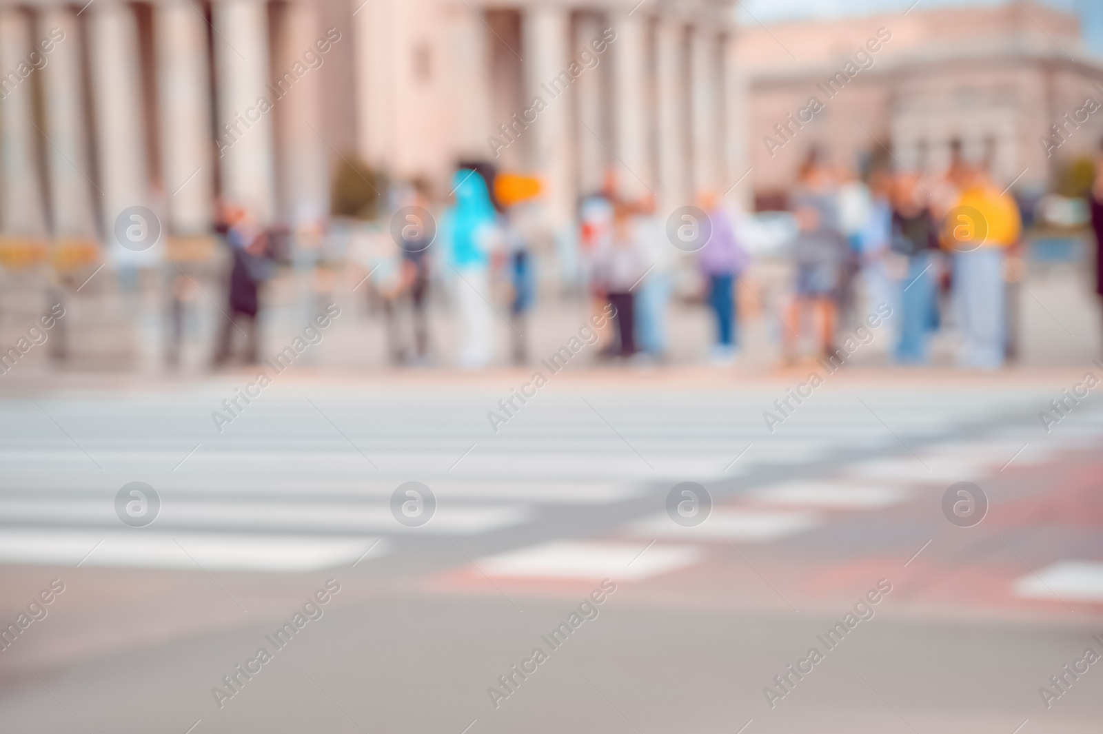 Photo of People waiting to cross street in city, blurred view