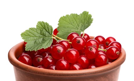 Photo of Tasty ripe redcurrants and green leaves in bowl isolated on white