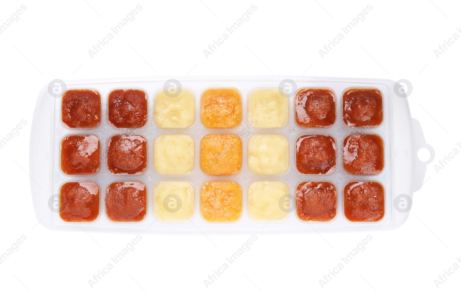 Photo of Different puree in ice cube tray on white background, top view. Ready for freezing