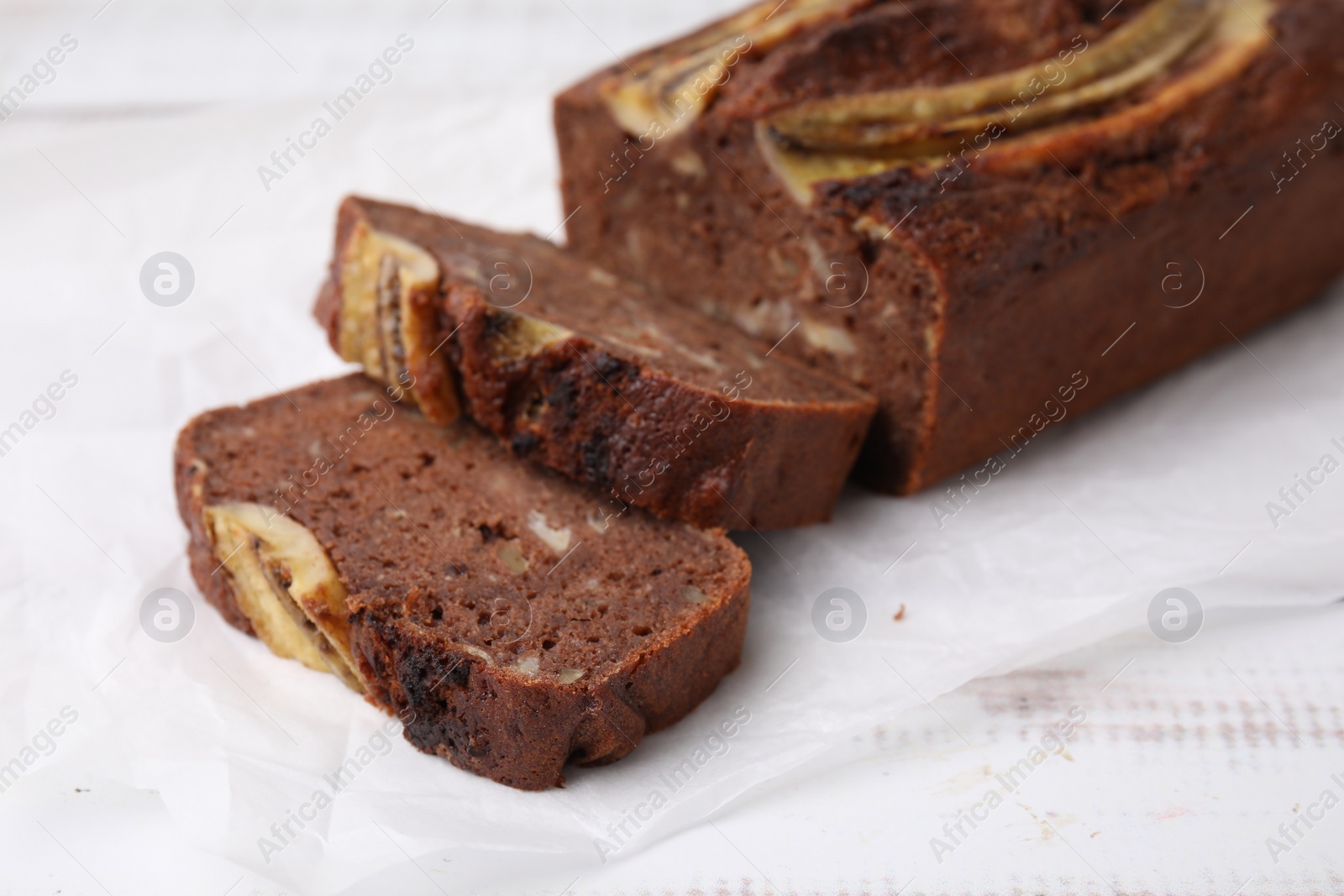 Photo of Delicious banana bread on white wooden table, closeup