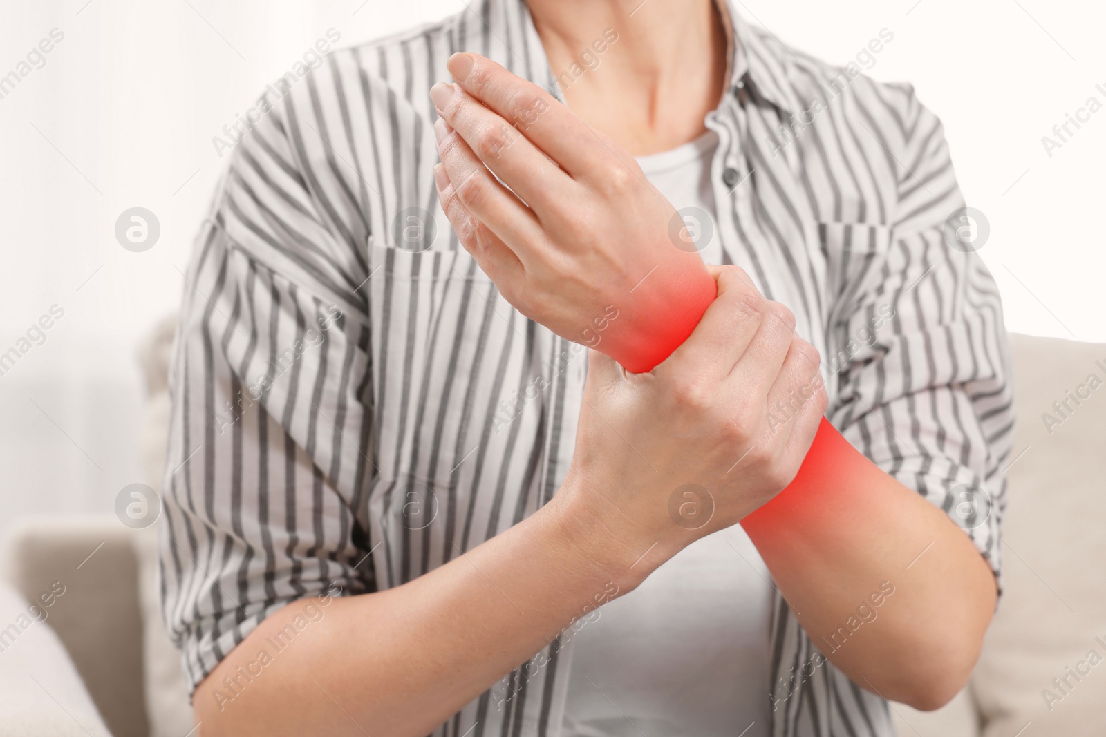 Image of Woman suffering from pain in hand indoors, closeup