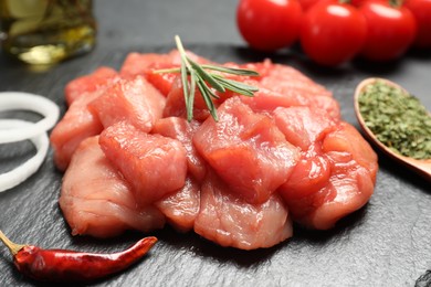 Cooking delicious goulash. Raw beef meat on slate board, closeup