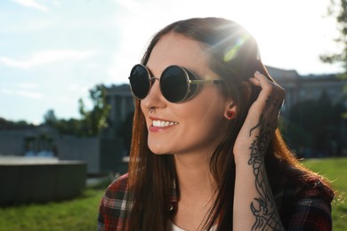 Beautiful young woman with nose piercing outdoors