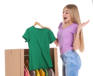 Photo of Young emotional woman near wardrobe box on white background