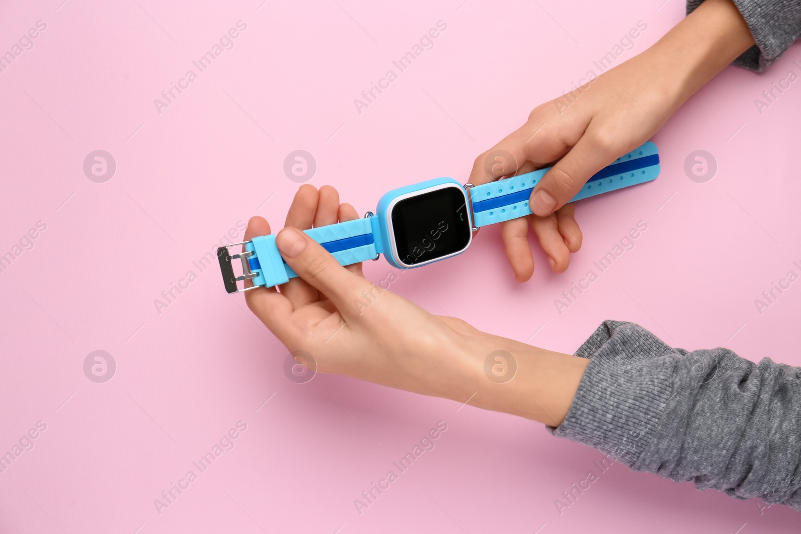 Photo of Boy with stylish smart watch on pink background, top view