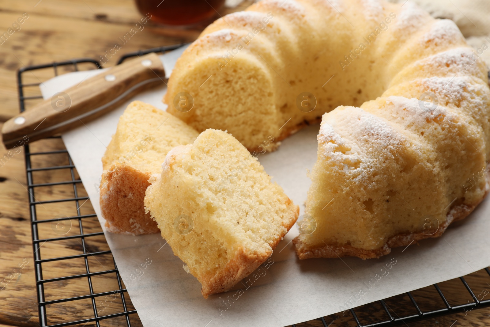 Photo of Delicious freshly baked sponge cake on wooden table, closeup